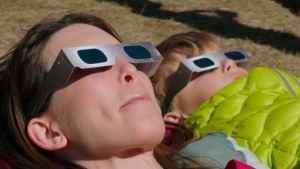 'It does kind of put you in your place': Calgary comes out to catch glimpse of solar eclipse