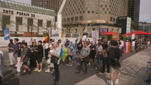 Hundreds walk backwards in downtown Montreal to symbolize the decline of LGBTQ2S+ rights