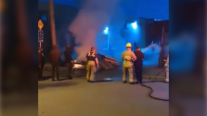 Video shows police officer taking firefighter's hose, spraying people in East Vancouver
