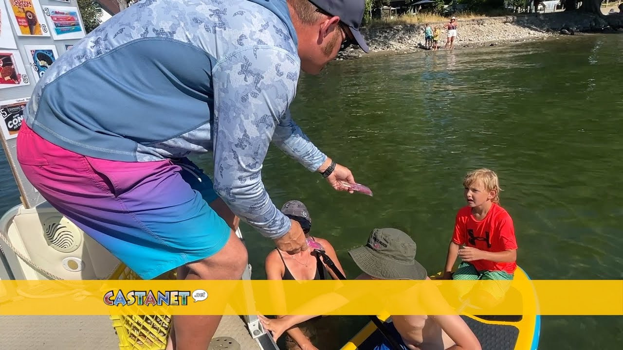 Purple Penguin Ice Cream Boat serving people on Okanagan Lake this summer