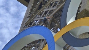 Police arrest shirtless man climbing the Eiffel Tower, prompting evacuation hours before closing ceremony